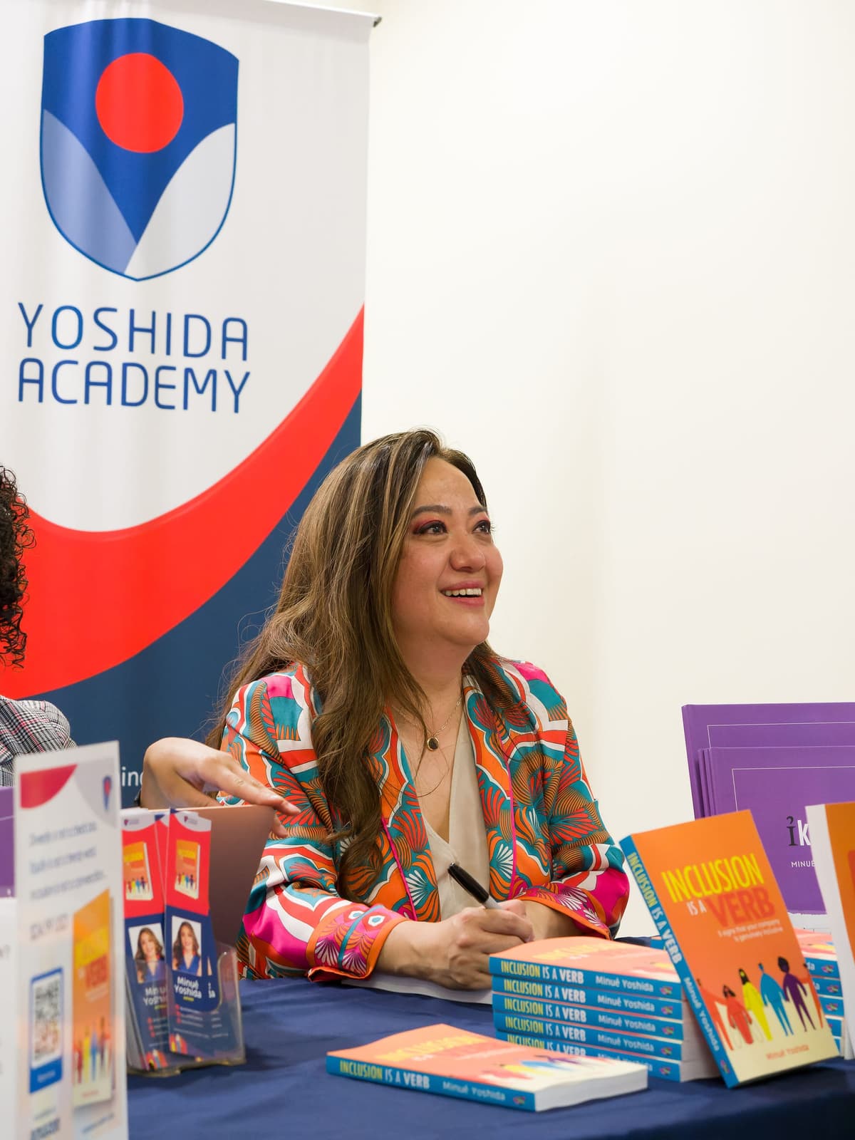 Minué Yoshida signing copies of Inclusion Is A Verb